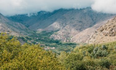 Scenic aerial view of Toubkal Valley in Morocco with lush greenery and mountains.