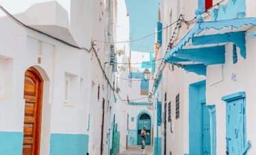 Scenic view of a colorful alley in Asilah, Morocco with traditional architecture.