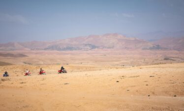 Group of quad bikers exploring the vast Agafay desert near Marrakech, Morocco.