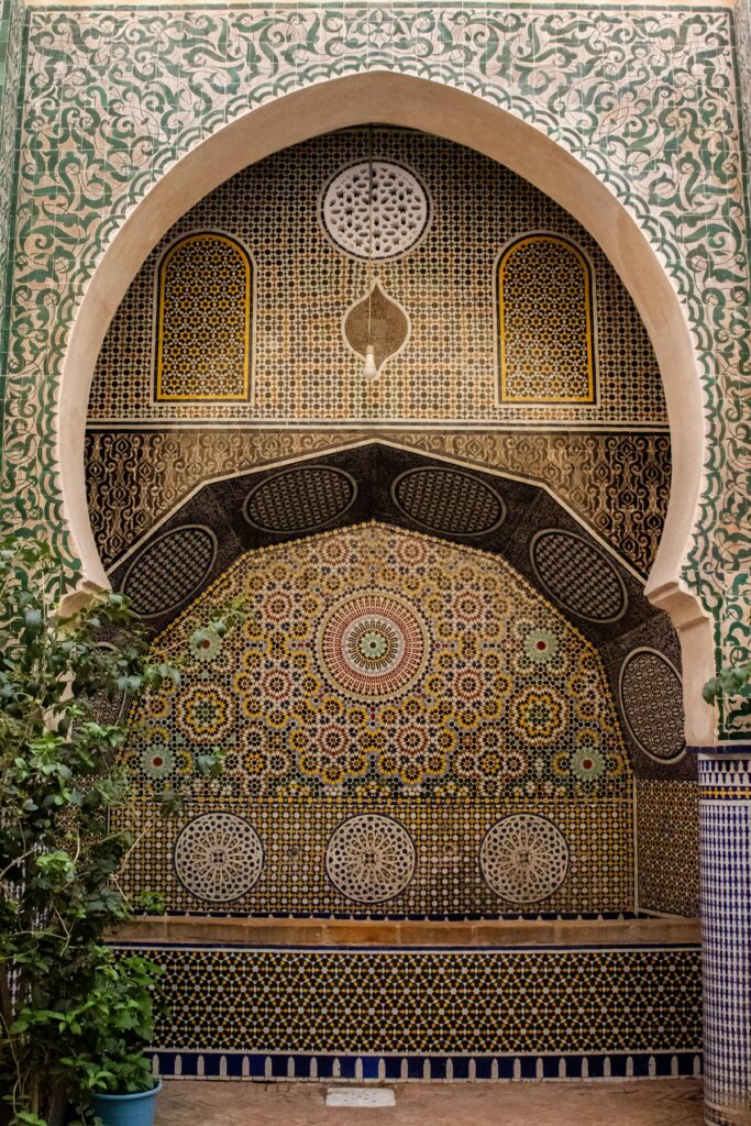 Detailed Moroccan mosaic and arches in a Fes, Morocco courtyard.