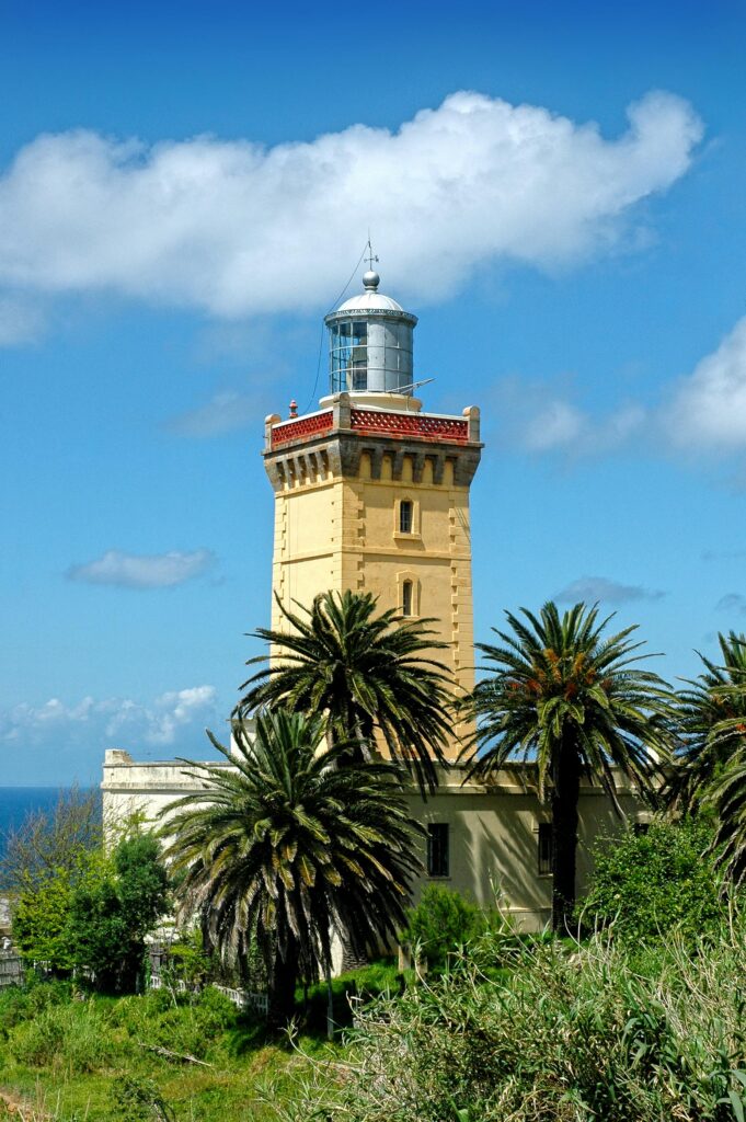 Stunning view of Cape Spartel Lighthouse amidst lush palm trees in Tangier.